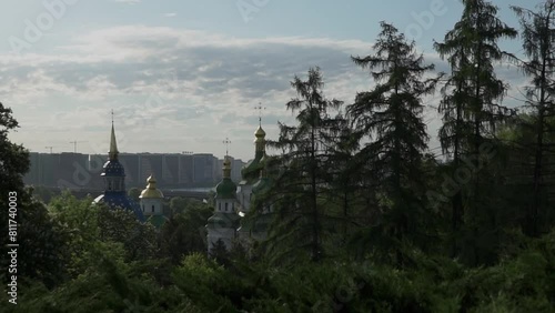 Summertime in the city. Kyiv, urban view with Vydubichi Orthodox Church, monastery photo
