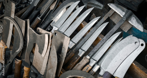 Various type of knives, axes, cleavers and other type of sharp tools on the display of an old hardware store. © Myst