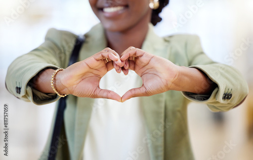 Black woman, business and hands with heart in office for gratitude, support and compassion for company goal. African female employee, corporate and love emoji or icon for kindness, hope and empathy