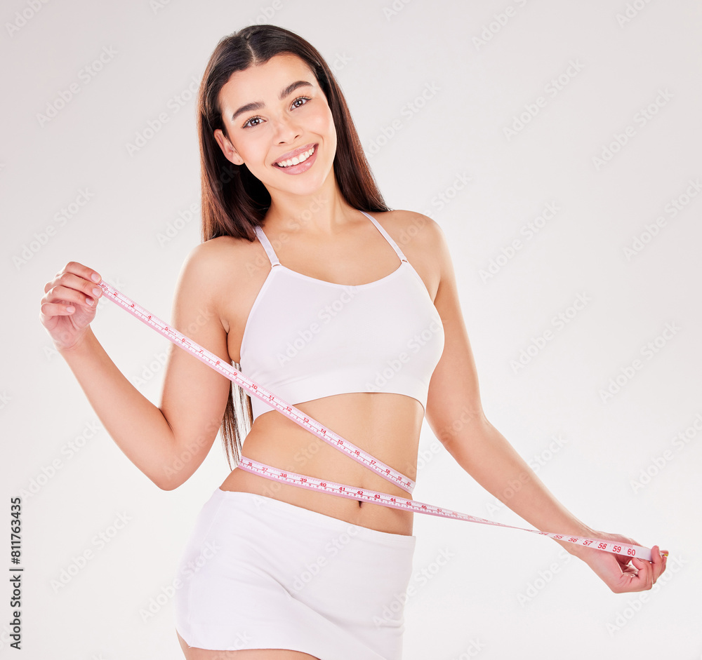 Woman, portrait and smile with measuring tape in studio for weight loss, results and progress of diet. Person, underwear and happy with bmi in body care, wellness and health on white background