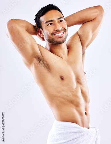 Muscle, man and shower with towel for hygiene on studio background thinking of skincare in mockup. Beauty, model and person grooming with cosmetics in healthy routine for self care and happiness