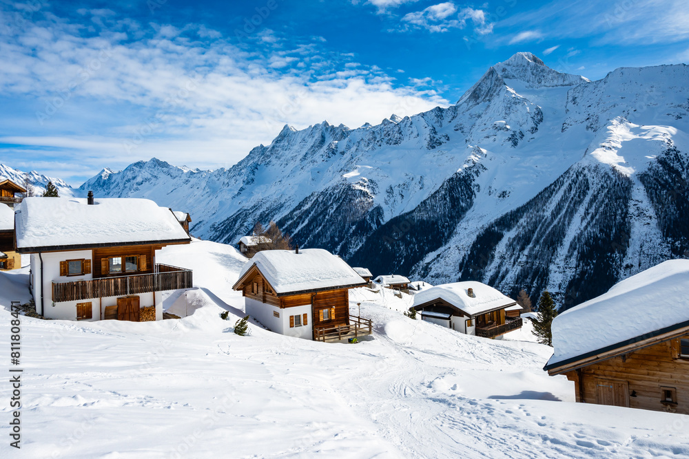 Traditional alpine wooden houses in winter mountain snow landscape, Loetschental valley, Switzerland