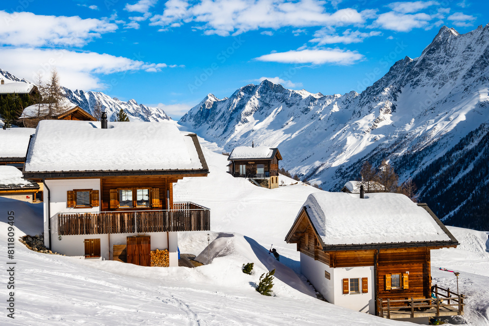 Traditional alpine wooden houses in winter mountain snow landscape, Loetschental valley, Switzerland