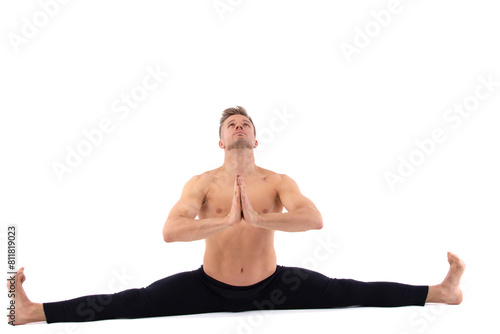 Sports and healthy lifestyle. An attractive man is doing yoga and pilates. White background.