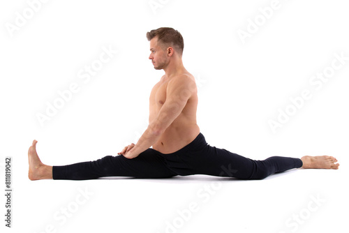 Sports and healthy lifestyle. An attractive man is doing yoga and pilates. White background.