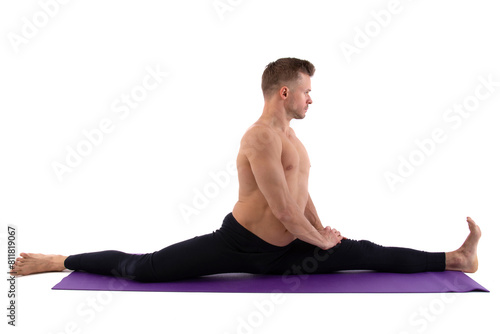 Sports and healthy lifestyle. An attractive man is doing yoga and pilates. White background.