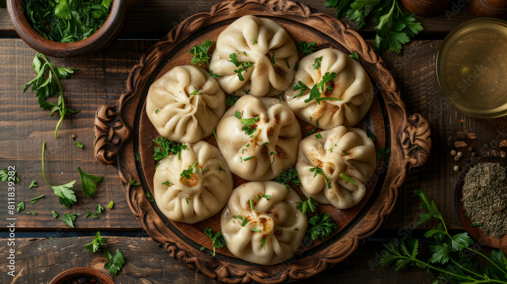 Georgian dumplings, known as khinkali, are a delicacy traditionally served on carved wooden plates with fresh herbs.