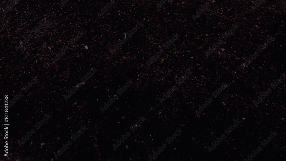 Fototapeta premium View of a red crystal pieces in a dark area