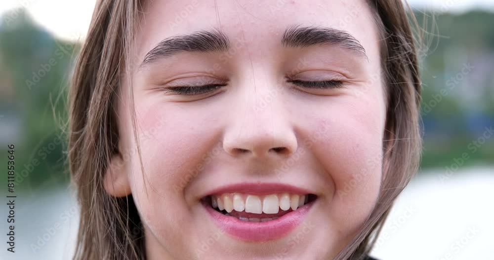 Outdoor closeup portrait, face of happy young beautiful stylish girl, smiling pretty brunette teenager with clean skin, natural cosmetics, makeup, looking at camera, soft smile Outdoor closeup portrait, face of happy young beautiful stylish girl, smiling pretty brunette teenager with clean skin, natural cosmetics, makeup, looking at camera, soft smile