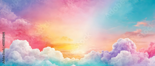 Colorful pastel summer background. Abstract colorful sky with fluffy clouds in bright pink, blue, teal, yellow, and purple rainbow colors with copy space