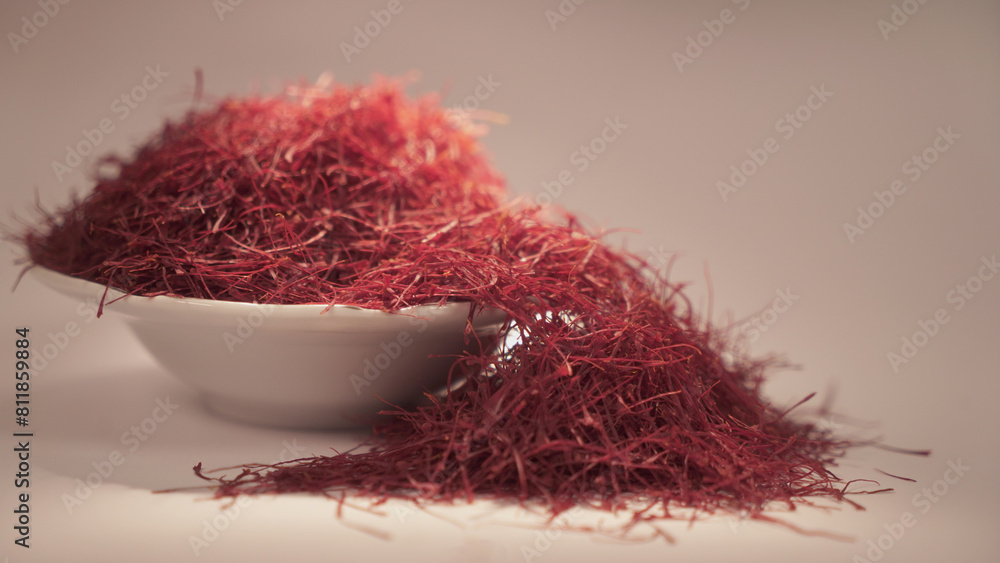 Fototapeta premium Dried saffron on ceramic cup. Isolated on gray background