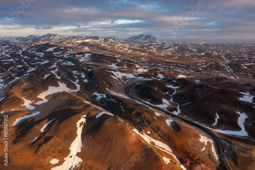 Cosmic mystical drone inspects snow-capped mountains and pseudo-craters. Myvatn in north of Iceland.