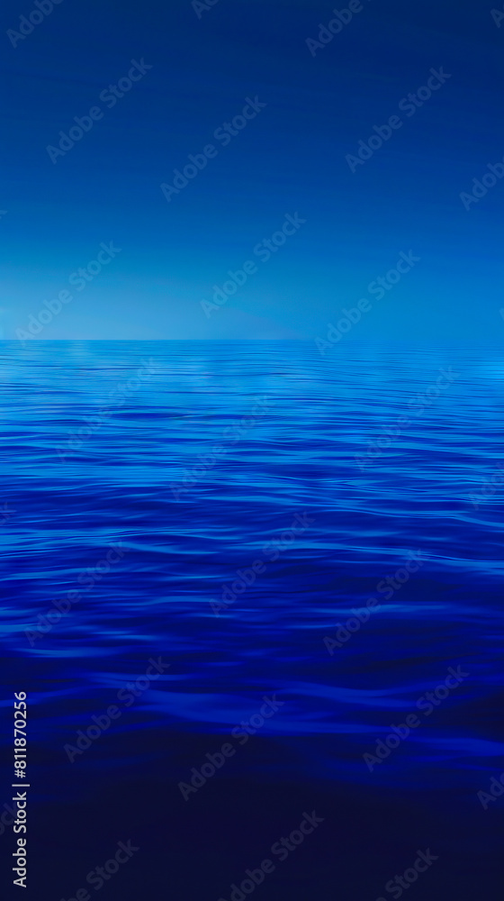 Fototapeta premium A blue ocean with a dark sky.