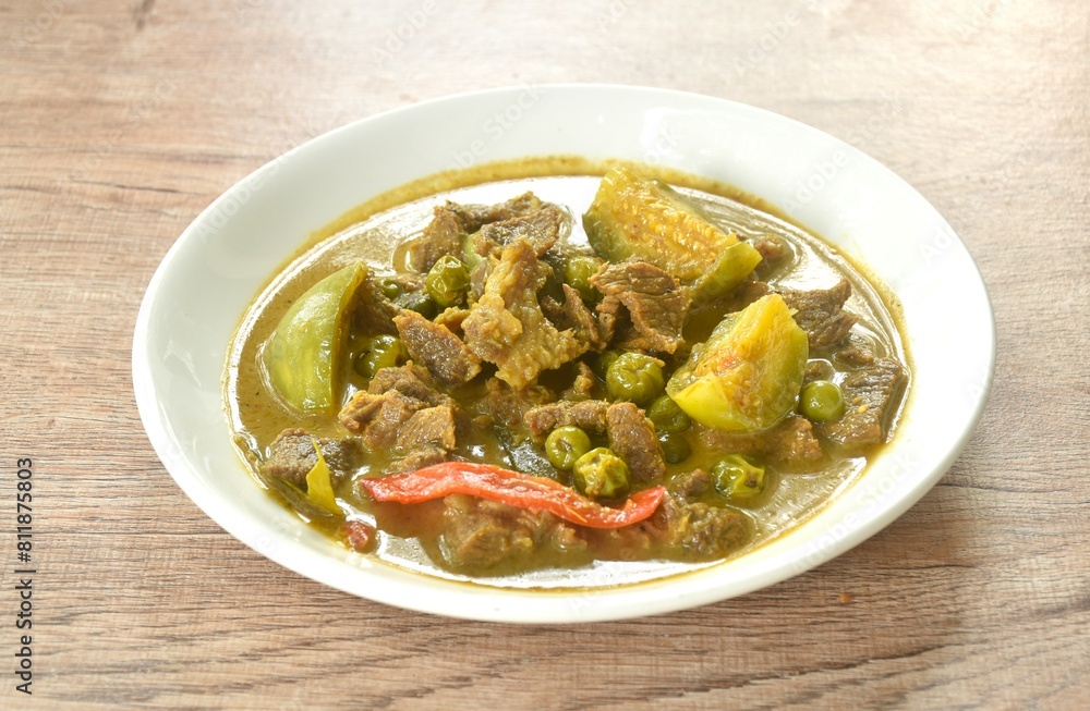 spicy boiled slice beef meat with eggplant in coconut milk green curry soup on plate spicy boiled slice beef meat with eggplant in coconut milk green curry soup on plate