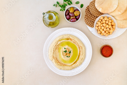 Hummus dip with chickpea, olives and pita bread . Top view