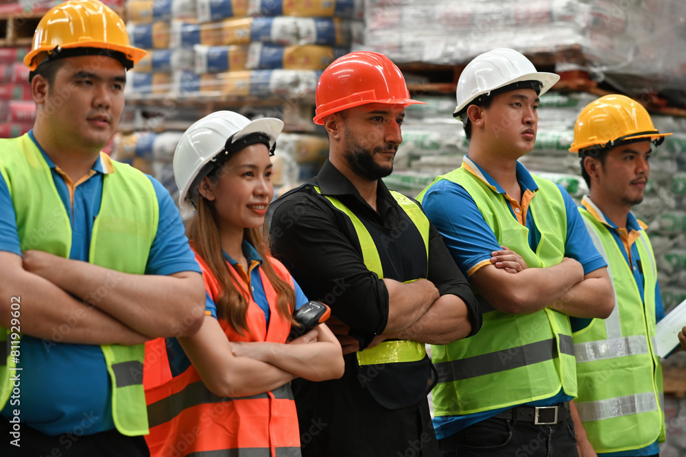 Portrait of a smiling group of diverse corporate colleagues warehouse standing in a row together Portrait of a smiling group of diverse corporate colleagues warehouse standing in a row together