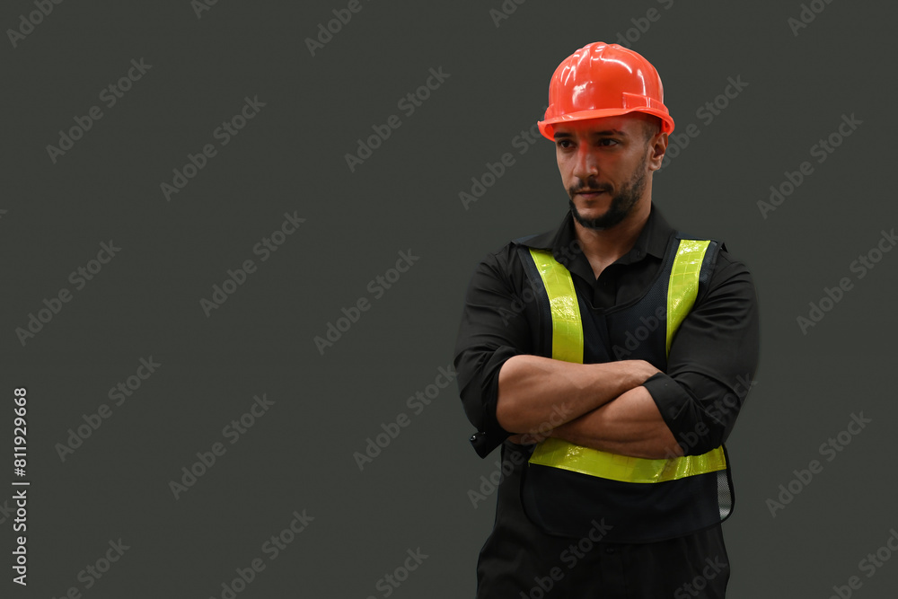 Portrait studio shot of a professional Caucasian man in an orange hard helmet and reflective safety vest, who is a welder or maintenance technician on color background Portrait studio shot of a professional Caucasian man in an orange hard helmet and reflective safety vest, who is a welder or maintenance technician on color background