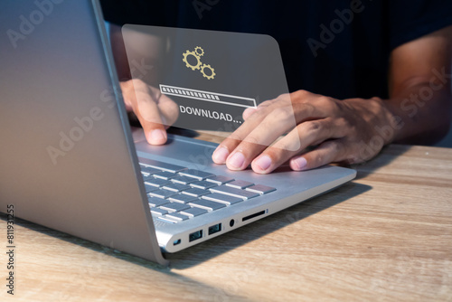 Fotografie Man using laptop to download media or update software