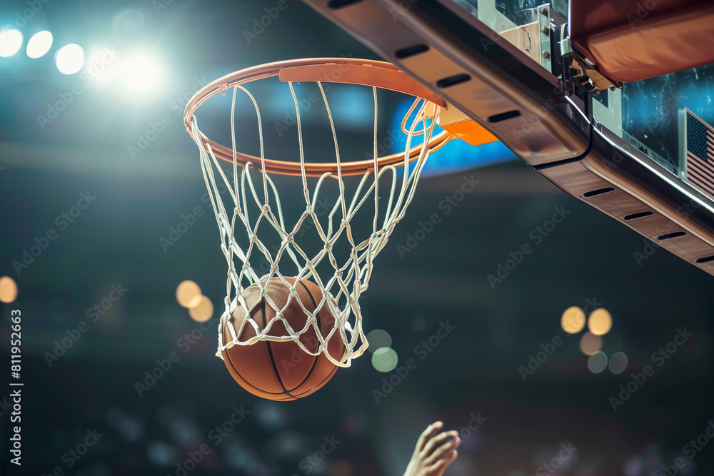 A basketball is in the air, about to go through a net. The image captures the excitement and anticipation of the game A basketball is in the air, about to go through a net. The image captures the excitement and anticipation of the game
