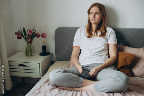Obraz na płótnie Upset young woman using phone and reading bad news, sad pensive girl sitting at home. Negative people emotion. Slow internet, access account trouble signing in, malfunction, need repair concept w salonie
