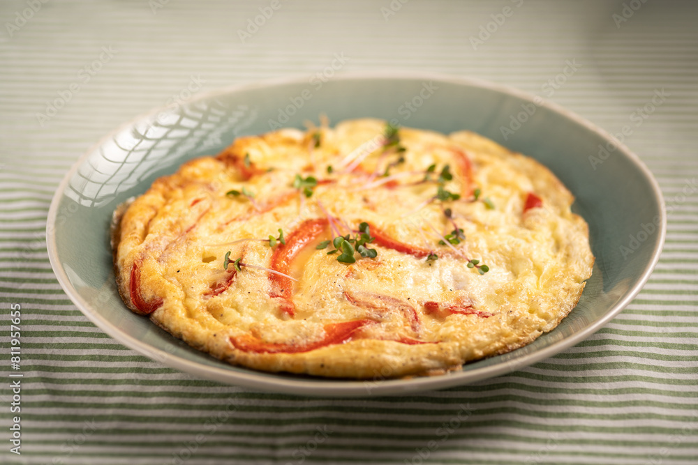 Healthy breakfast concept. Whipped eggs fried with red sweet pepper on a plate. Delicious hot omelette diet food Healthy breakfast concept. Whipped eggs fried with red sweet pepper on a plate. Delicious hot omelette diet food