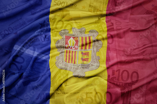 waving colorful national flag of andorra on a euro money banknotes background. finance concept. .