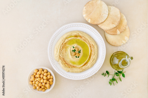 Hummus dip with chickpea, olives and pita bread . Top view