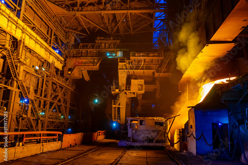 Iron works in a metallurgical plant at night. Industrial background