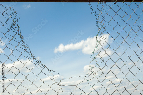 Broken metal mesh fence