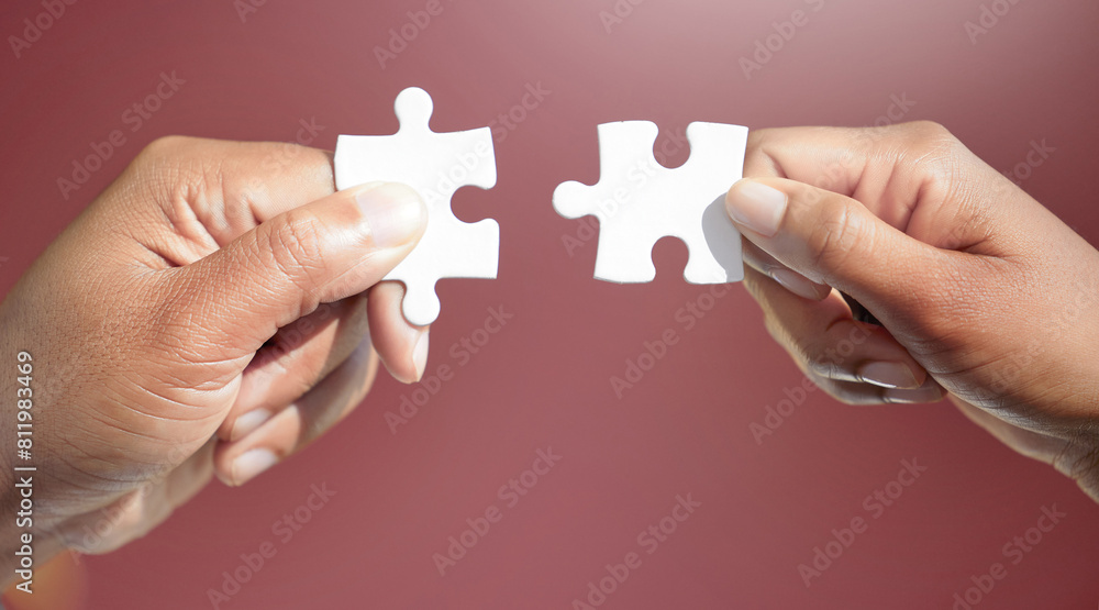 Hands, puzzle and jigsaw for people in studio for connection, teamwork and link by red background. Colleagues, game and toys for synergy, collaboration and strategy with problem solving in office Hands, puzzle and jigsaw for people in studio for connection, teamwork and link by red background. Colleagues, game and toys for synergy, collaboration and strategy with problem solving in office