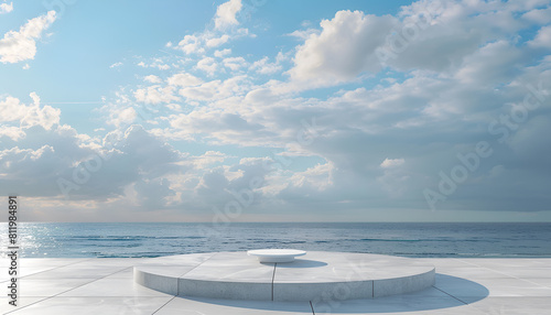 white concrete podium on a tile floor  against a serene ocean and cloudy sky background