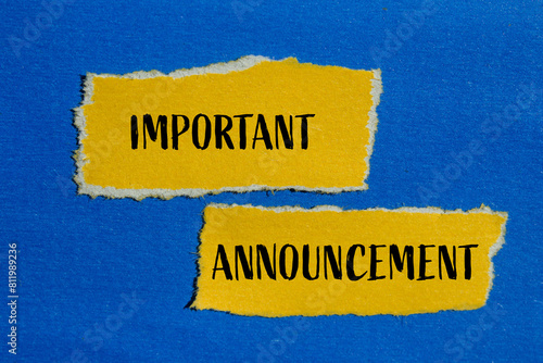 Φωτογραφία Important announcement words written on ripped yellow paper pieces with blue background