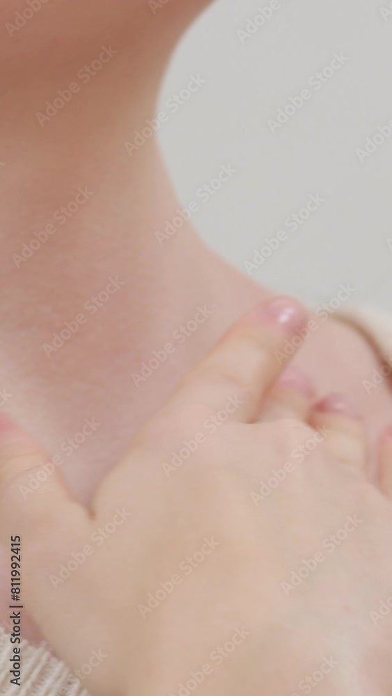 Neck massage. Young woman sitting on sofa and experiencing neck pain Neck massage. Young woman sitting on sofa and experiencing neck pain