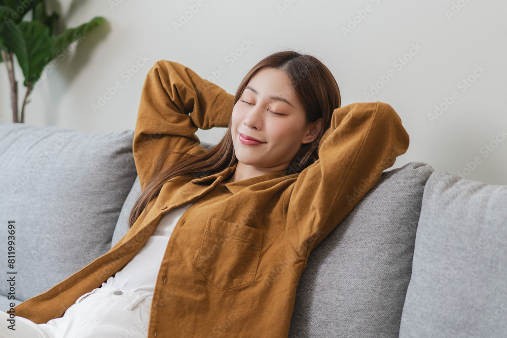 Young woman enjoying mind free moment relax and calm on the sofa at home. Young woman enjoying mind free moment relax and calm on the sofa at home.