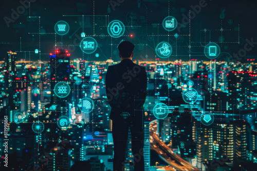 A man in a suit looks out over a city at night