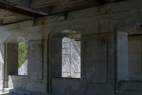 arch supports made of cement under a bridge photo