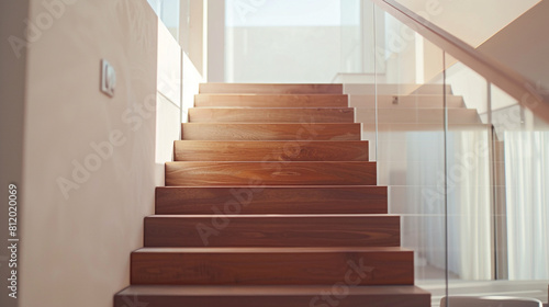 Luxury home staircase combining the warmth of wood with the clarity of glass set in a minimalist design