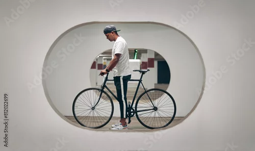 Obraz Architecture, bicycle and man with creativity, design and bike with thinking for ideas and vision. Transport, cool and trip or journey for adventure, travel and fitness with workout and hobby