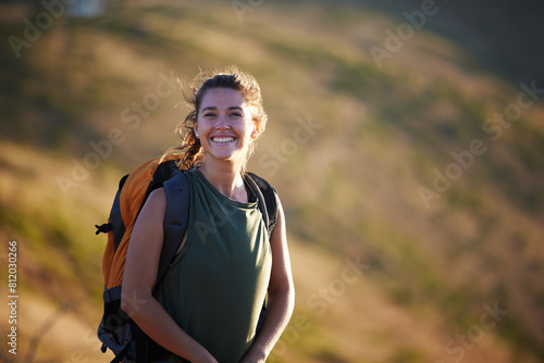 Hiker, mountain and portrait in environment for landscape, nature or adventure for extreme sport, travel and explore. Woman, smile and trail for recreation, hiking and journey with backpack on mockup © peopleimages.com