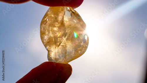 Tableau sur toile A citrine stone held towards the sun in close-up