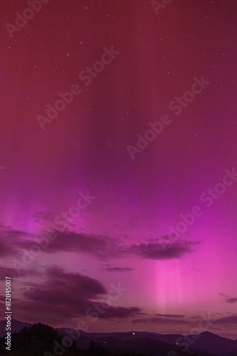 Beautiful violet pink red aurora borealis the northern lights over the horizon in Slovenia. © L3V3C