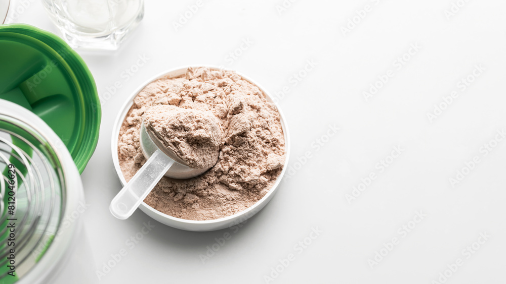 Whey protein powder in measuring scoop Whey protein powder in measuring scoop