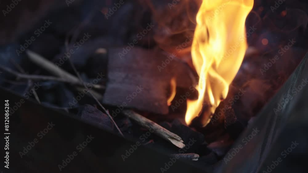 Slow motion shot of charcoal in brazier, preparation for bbq Slow motion shot of charcoal in brazier, preparation for bbq