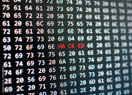 Dramatic digital security breach concept, 'hacked' alert on computer screen