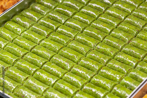 Green pistachio roll baklava. Traditional Turkish cuisine delicacies. Local name fıstıklı sarma baklava background. selective focus