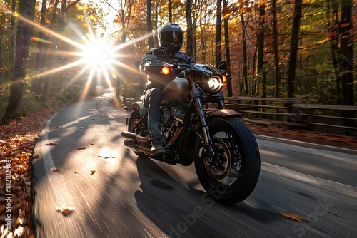 Digital image of  motorcyclist is riding down a road in the woods