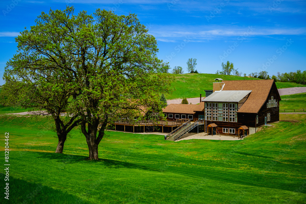 Tranquil Vibrant Springtime Landscape with tall oak trees and houses nestled at Great Bear Ski Valley in South Dakota, USA