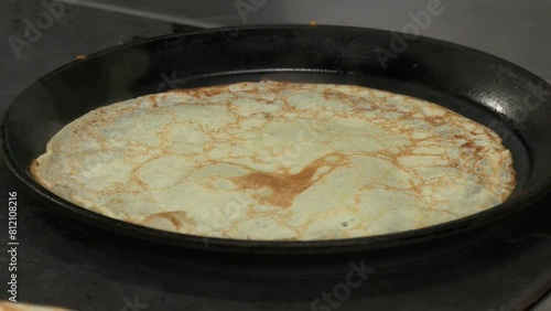 Wallpaper Mural A pancake being flipped by a black spatula in a frying pan. Close-up. Making Pancakes on frying pan. Making Crepes on frying pan. 
 Torontodigital.ca