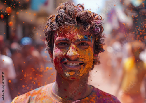 Portrait of young Indian man enjoying at Holi festival.