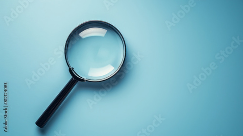 minimalist blue background with magnifying glass emphasizing clarity photo